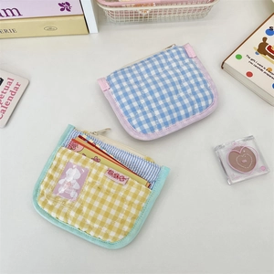 Detailed view of quilted heart pattern and zip closure on colorful cotton card pouches