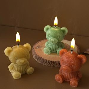 Three teddy bear scented candles with sweater texture in yellow green and red