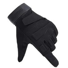 Detail of black tactical gloves with reinforced knuckles and adjustable velcro wrist straps