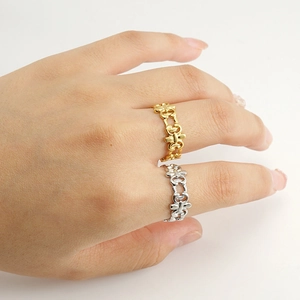 Close-up of gold and silver geometric hollow rings stacked on female fingers