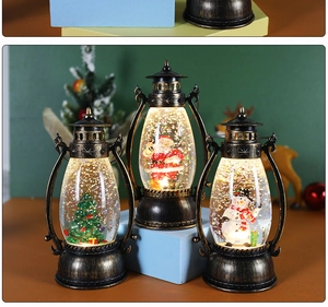 Close-up of three vintage Christmas lanterns with Santa, Snowman and Tree figurines