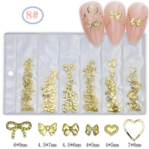 Golden metal nail art charms set with bowknot and heart shapes in six-grid storage case