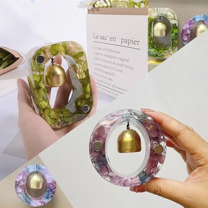 Detail of resin doorbells with real dried flowers and golden metal bells