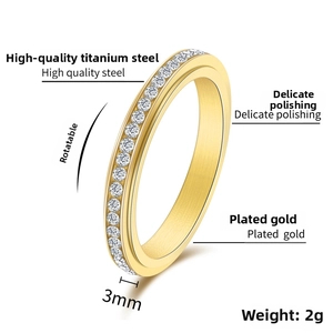 Detail view of 3mm gold spinner ring with inlaid cubic zirconia and polished titanium steel