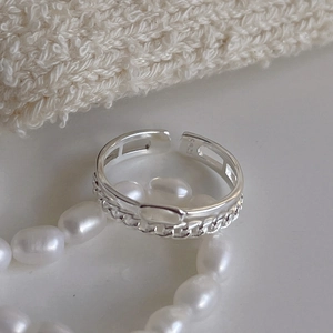 Detail of 925 sterling silver double chain ring on soft knit fabric with pearls