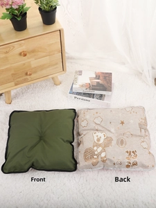 Detailed view of cooling pet mat showing dark green solid side and cute bear pattern side