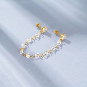 Detailed close-up of gold S925 sterling silver chain earrings with clear zircon stones