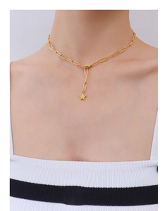 Detail of 18k gold plated link chain necklace with star pendant on female neck