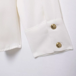 Commuter style white crepe shirt with shoulder ornaments and gold button sleeve details