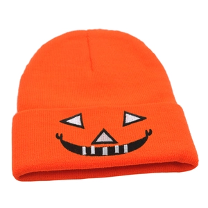 Orange Halloween knit beanie featuring a black and white pumpkin smile embroidery