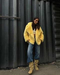 Street style shot of yellow faux fur jacket with a lapel collar and plush texture