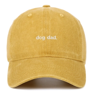 Detail of embroidered dog dad text on ginger washed cotton baseball cap with white background