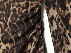 Detail of leopard print dress with side ruching and soft chiffon fabric texture