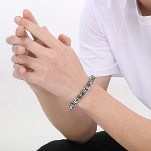 Silver Byzantine style chain bracelet for men shown on wrist in a street fashion style
