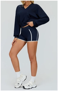 Detail view of navy blue hooded sports sweatshirt and athletic shorts with white piping
