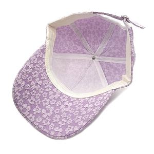 Detail of lavender floral baseball cap interior with white sweatband and metal buckle