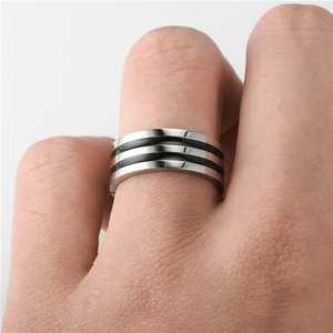 Close-up of titanium steel ring with three black stripes on male model's hand