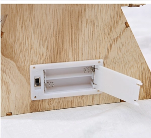 Detail of wooden Christmas ornament base with battery compartment and power toggle switch