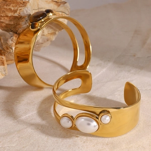 Golden stainless steel open bangles featuring tiger eye stone and white pearl accents