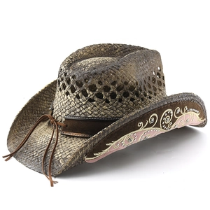 Detailed close-up of straw cowboy hat with rhinestone embroidery and woven texture