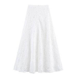Detail view of white lace skirt with intricate hollow-out floral patterns and A-line cut
