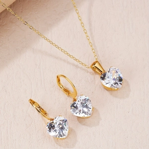 Detailed view of heart-shaped zircon jewelry set with gold necklace and leverback earrings