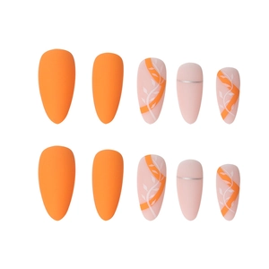 Matte orange and nude almond press-on nails featuring white leaf art and silver lines