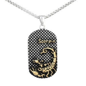 Macro shot of Scorpio pendant with golden scorpion relief on a mesh-textured silver base