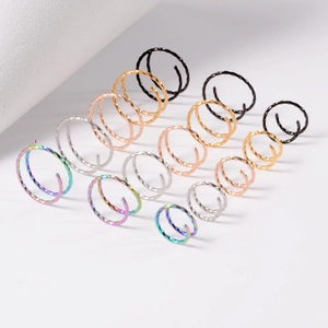 Macro view of assorted 20G stainless steel spiral double nose rings in multiple colors