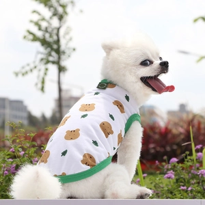 Close-up of pet vest featuring cute brown bear prints and green trim on soft white fabric