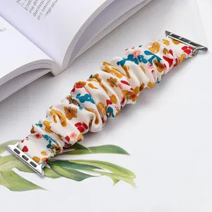 Detailed view of floral scrunchie watch band with silver connectors on Apple Watch