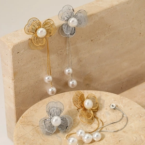 Elegant hollow flower tassel earrings with white pearls and gold metallic finish for women