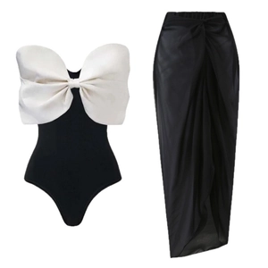Elegant one-piece swimsuit with large white bow and matching black sarong wrap skirt