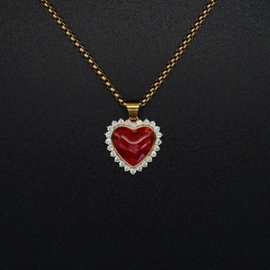 18K gold stainless steel heart necklace with red stone and zircon pavé on black background
