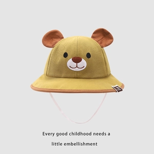 Detail of a yellow bear-themed toddler sun hat with cute 3D ears and white windproof rope