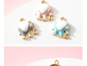 Macro view of pink, grey, and blue elephant alloy pendants with gold trim for DIY jewelry