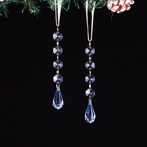 Blue acrylic beaded ornaments with teardrop pendants and white ribbons for festive decor