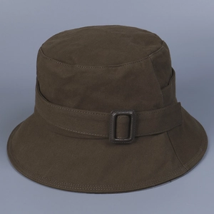 Detail of deep brown bucket hat featuring a leather buckle and structured canvas fabric