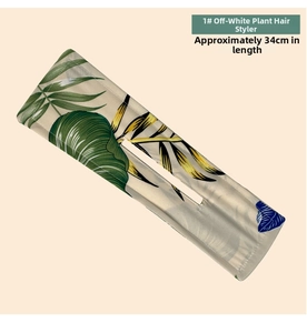 Close-up of a 34cm floral deft bun maker with tropical green leaves on a cream background