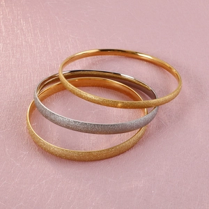 Three-piece stackable titanium steel bangles in gold and silver matte and polished finishes