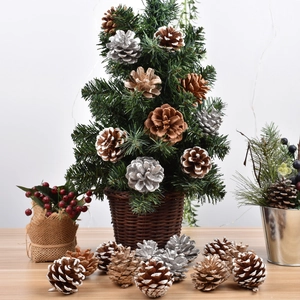 Christmas pine cone ornaments and mini trees in a woven basket for holiday window display