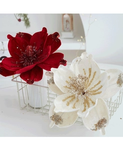Detail of velvet magnolia flowers with glitter edges in a white iron basket decor