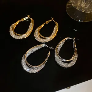 Gold and silver layered mesh hoop earrings featuring a sparkling textured outer ring finish