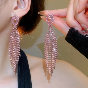 Detailed view of pink rhinestone tassel earrings with a glossy silver needle finish