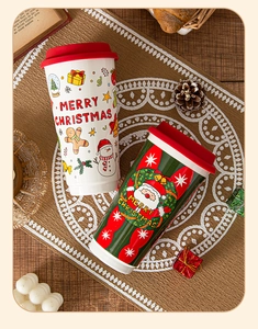 Detail of Christmas ceramic travel mugs with silicone lids and festive snowman patterns