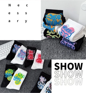 Detailed macro of crew socks featuring vibrant graffiti street style and urban typography