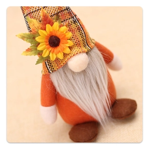 Close-up of autumn gnome plush with sunflower orange plaid hat and maple leaf detail