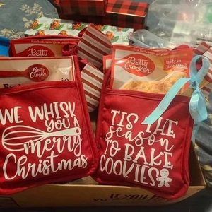 Close-up of red Christmas pot holder with baking mix pocket and white festive holiday print