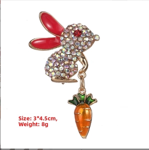 Detailed close-up of a cute rabbit brooch with colorful rhinestones and carrot pendant
