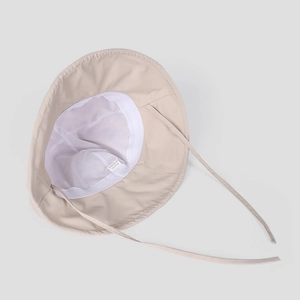 Detail view of beige sun hat featuring breathable mesh lining and adjustable strap